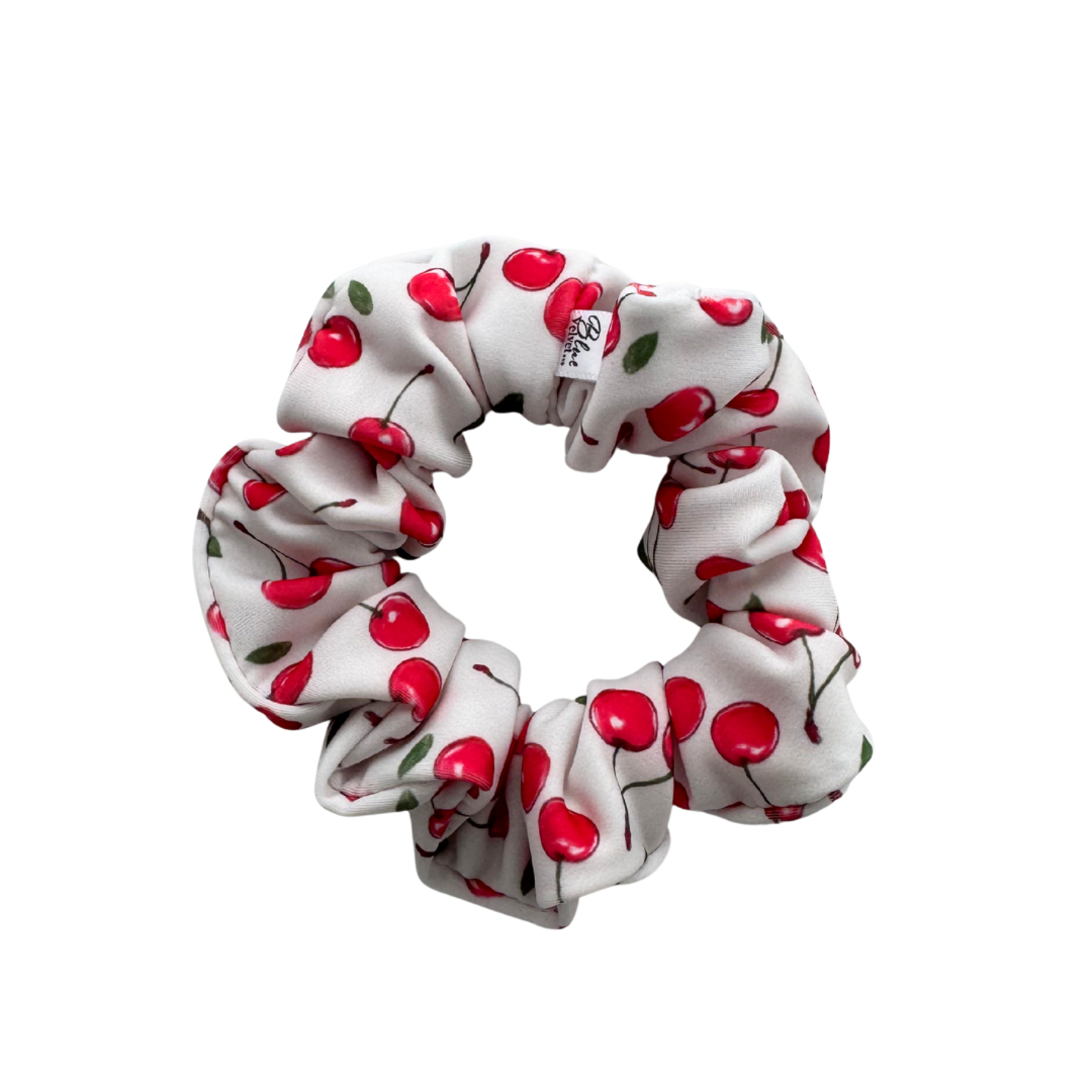 White swim scrunchie with red cherry pattern.