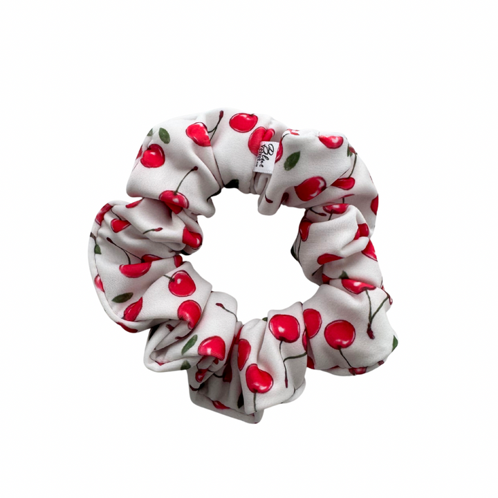 White swim scrunchie with red cherry pattern.