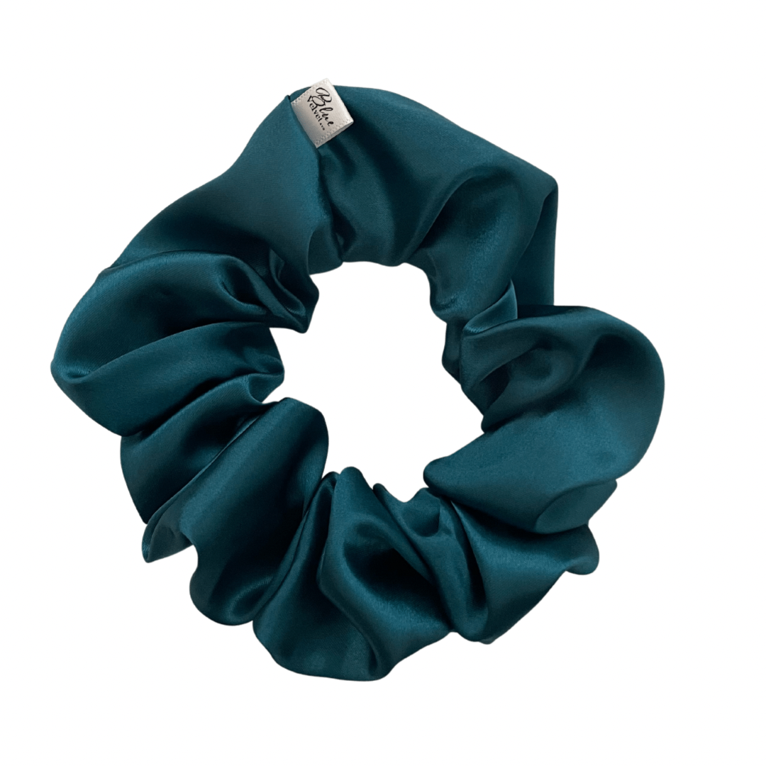 A deep teal satin scrunchie displayed on a white background.