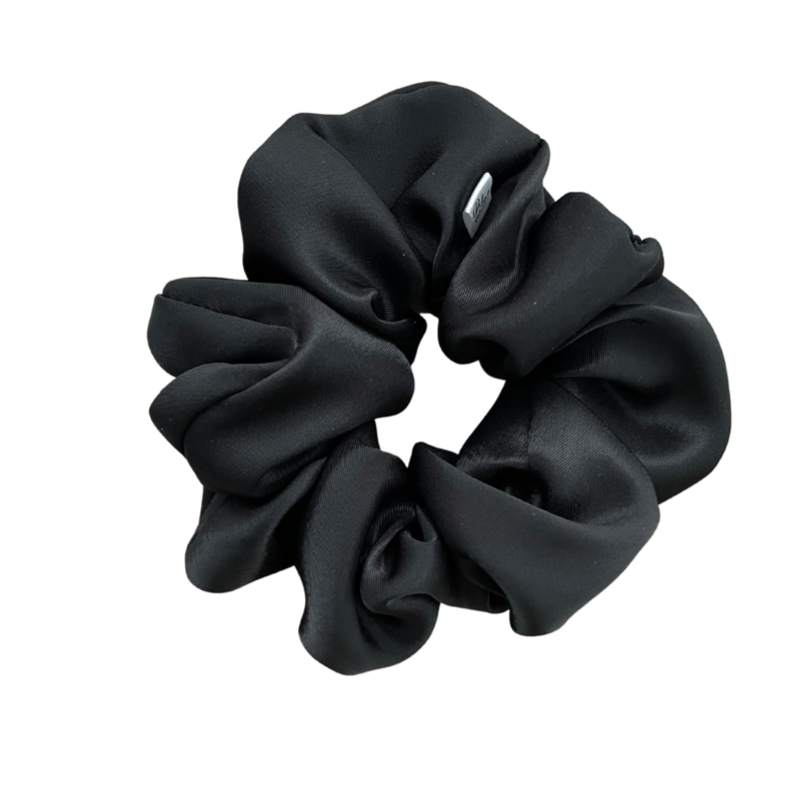 A black satin scrunchie isolated on a white background.