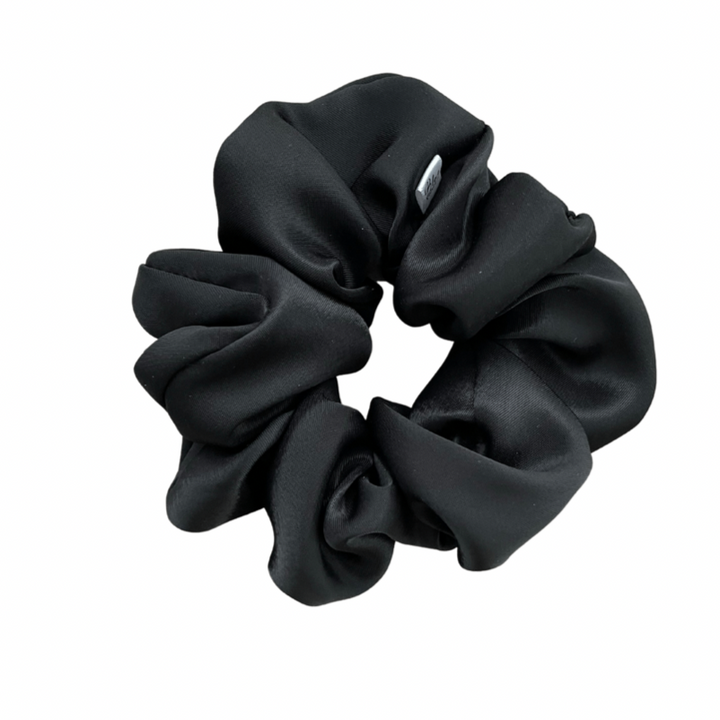 A black satin scrunchie isolated on a white background.